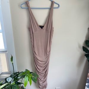 Large fitted tan dress.